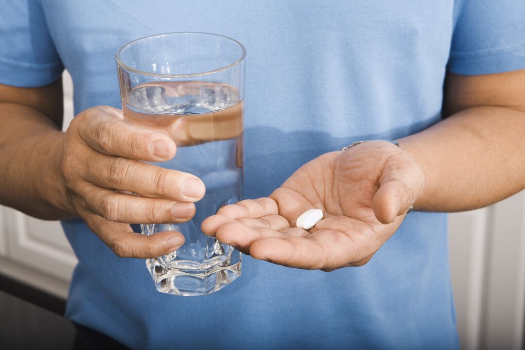 a man drinking a pill for parasites
